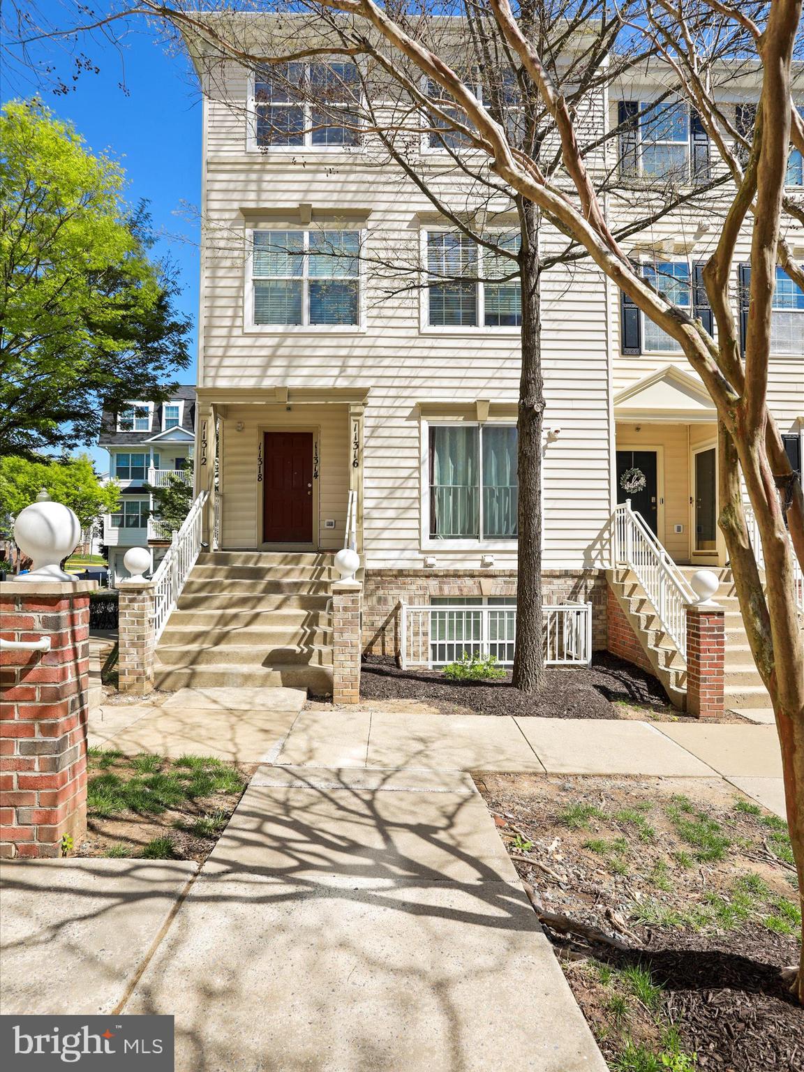 11312 King George Drive, Unit 4 Wheaton, MD 20902 - Photo 4 of 28 a view of a house with cars parked in front of a house