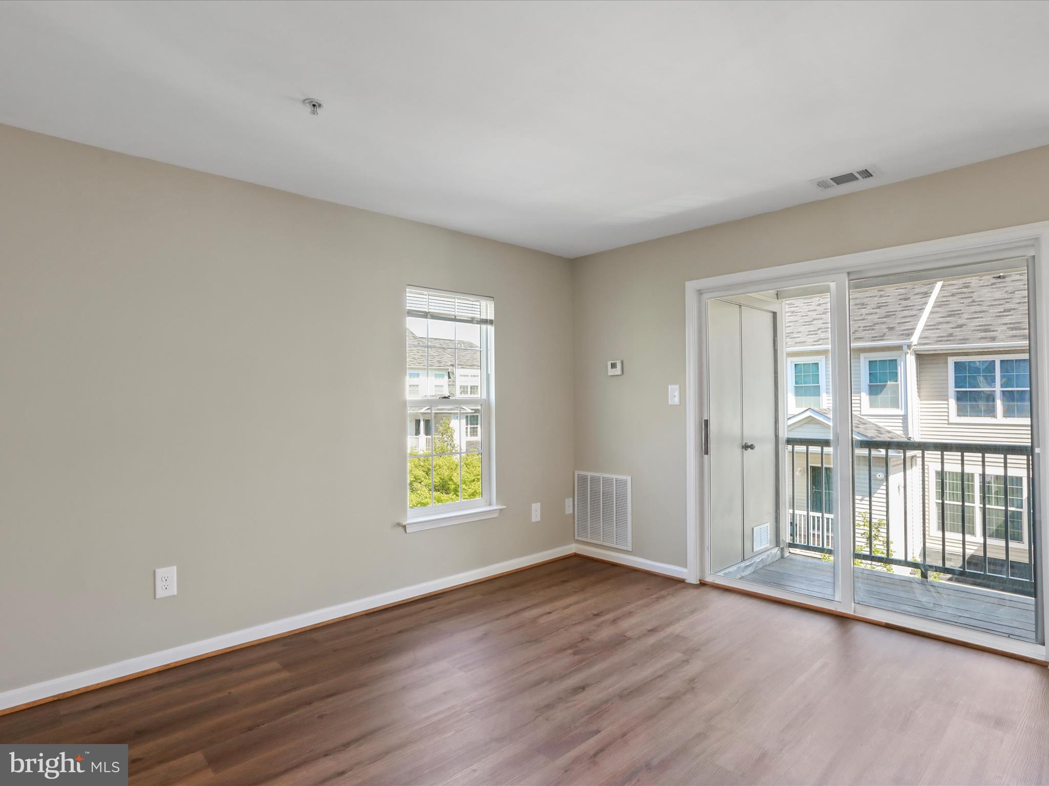 11312 King George Drive, Unit 4 Wheaton, MD 20902 - Photo 6 of 28 a view of an empty room with wooden floor and a window