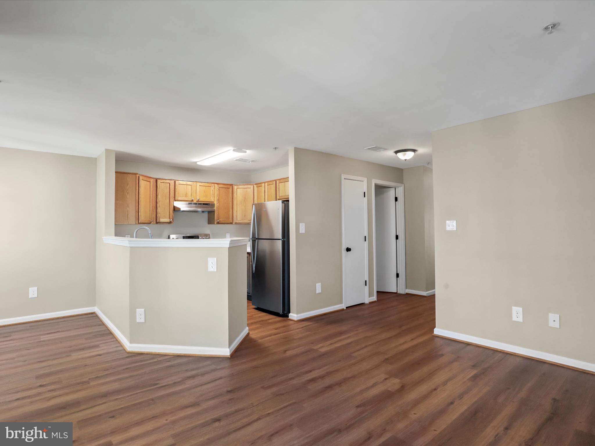 11312 King George Drive, Unit 4 Wheaton, MD 20902 - Photo 8 of 28 a view of a kitchen with wooden floor and electronic appliances