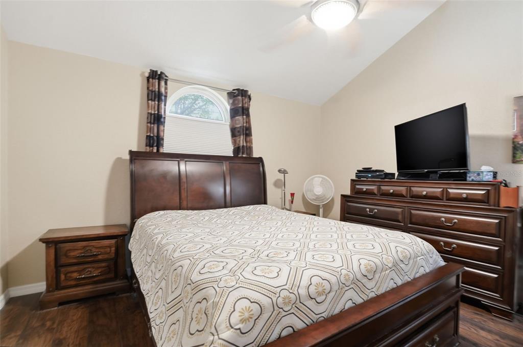 2658 Royal Ridge Drive Spring Hill, FL 34606 - Photo 13 of 38 a bedroom with a bed and a flat screen tv