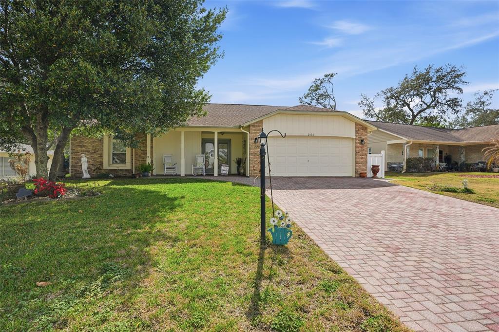 2658 Royal Ridge Drive Spring Hill, FL 34606 - Photo 22 of 38 a front view of a house with garden