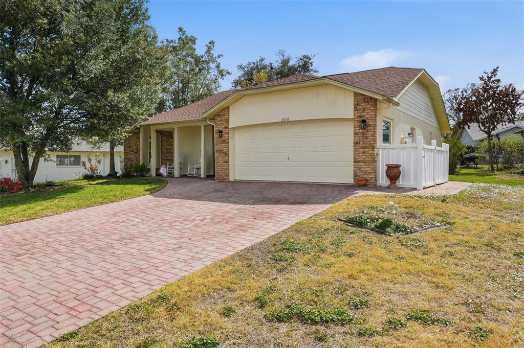 2658 Royal Ridge Drive Spring Hill, FL 34606 - Photo 29 of 38 a front view of a house with a yard and garage