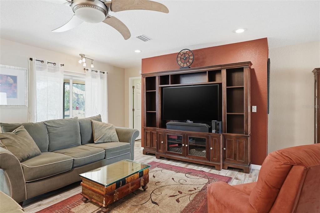 2658 Royal Ridge Drive Spring Hill, FL 34606 - Photo 34 of 38 a living room with furniture and a flat screen tv