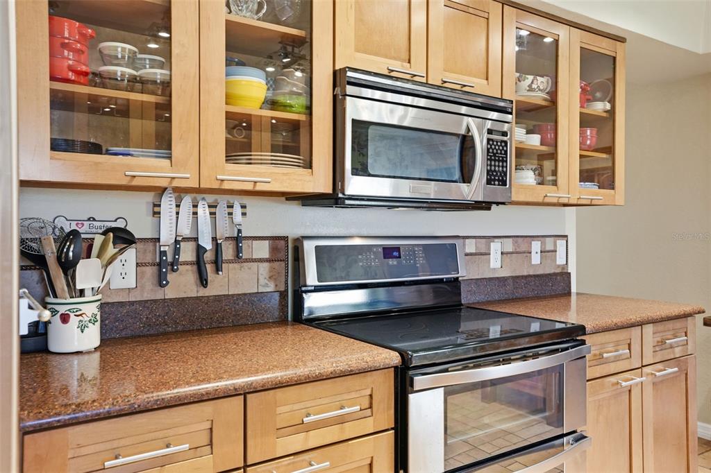 2658 Royal Ridge Drive Spring Hill, FL 34606 - Photo 35 of 38 a kitchen with a stove and a microwave
