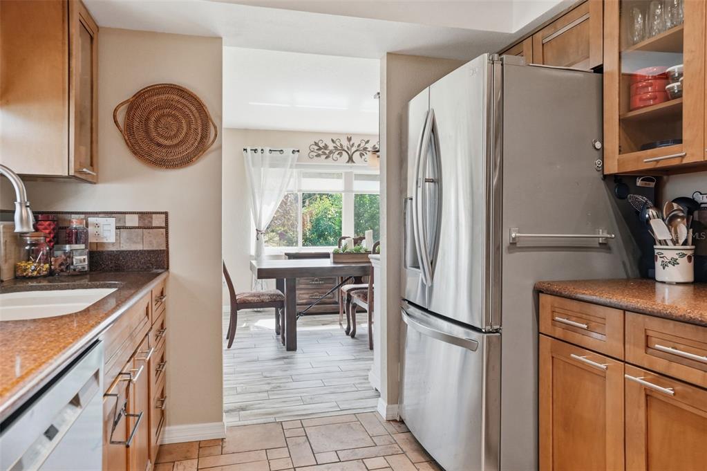 2658 Royal Ridge Drive Spring Hill, FL 34606 - Photo 4 of 38 a kitchen with stainless steel appliances granite countertop a refrigerator and a stove