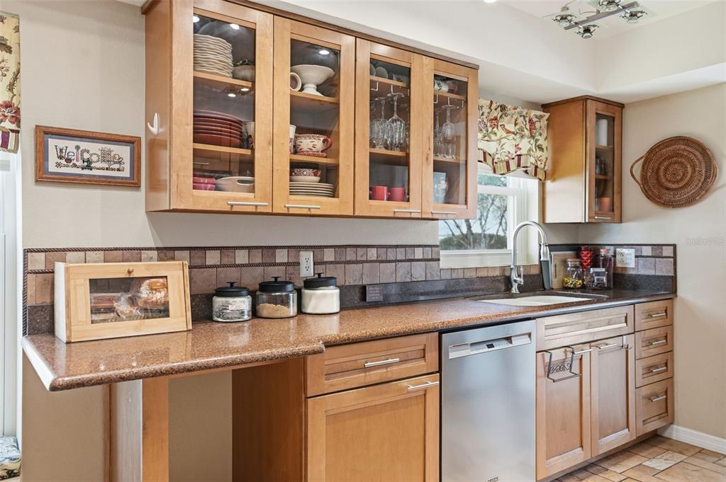 2658 Royal Ridge Drive Spring Hill, FL 34606 - Photo 5 of 38 a kitchen with stainless steel appliances granite countertop a sink and a stove next to a window
