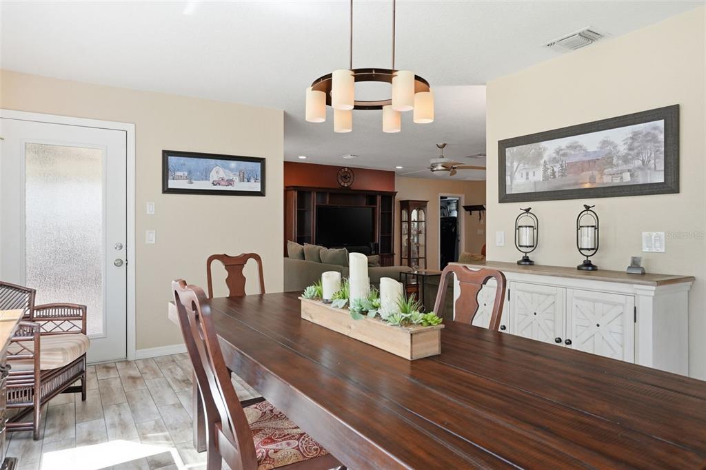 2658 Royal Ridge Drive Spring Hill, FL 34606 - Photo 5 of 38 a view of a dining room with furniture wooden floor and chandelier