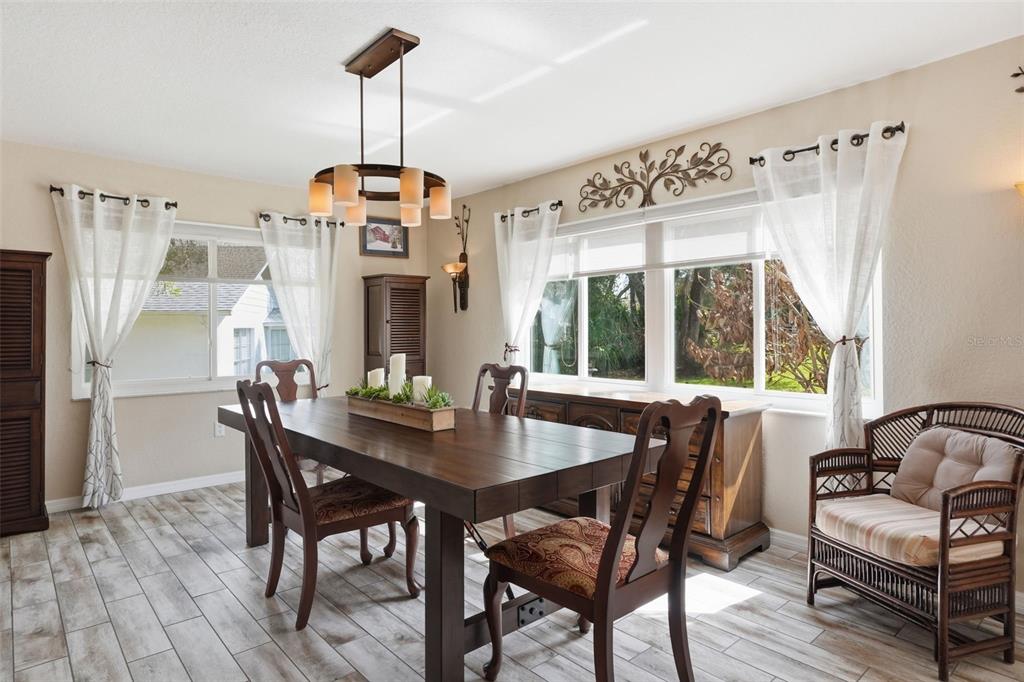 2658 Royal Ridge Drive Spring Hill, FL 34606 - Photo 9 of 38 a dining room with furniture window wooden floor