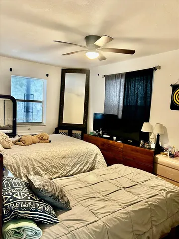 a bedroom with a bed and a large mirror