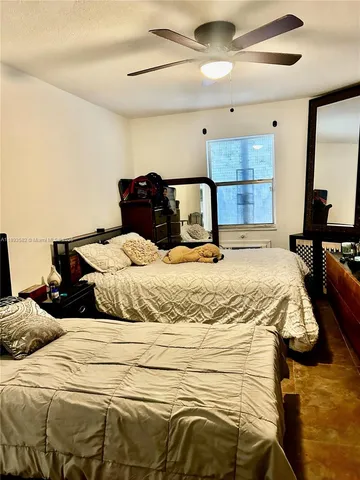 a bedroom with a bed and a mirror