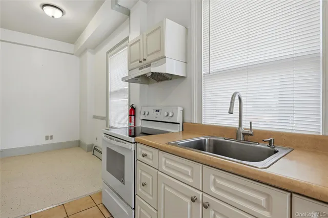 a kitchen with stainless steel appliances a sink and a stove