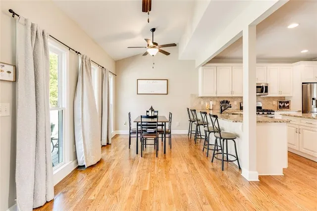 a kitchen with a refrigerator a microwave a sink and cabinets