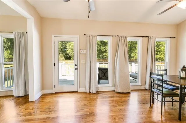 a view of a dining room with furniture and a kitchen