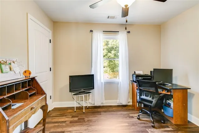 a spacious bedroom with a bed and glass window