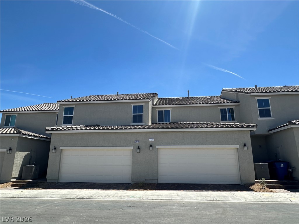 2121 Tricase Street Henderson, NV 89044 - Photo 1 of 31 View of front of home with stucco siding, a garage, and cooling unit