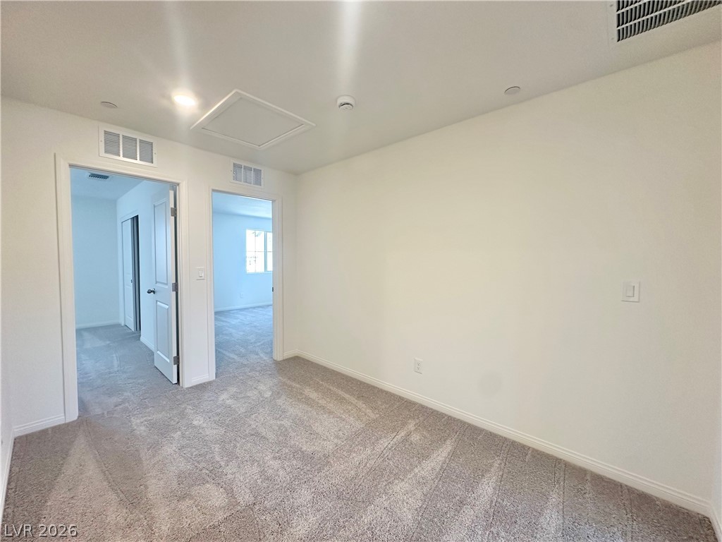 2121 Tricase Street Henderson, NV 89044 - Photo 14 of 31 Spare room featuring carpet, attic access, baseboards, and a smoke detector