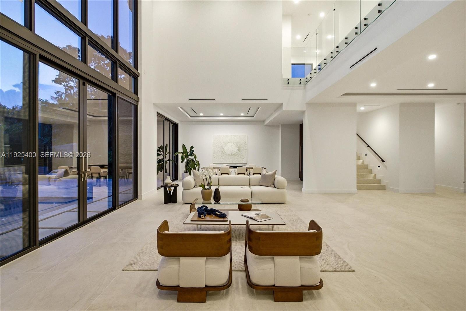 9840 Southwest 73rd Court Pinecrest, FL 33156 - Photo 11 of 67 Living Room | Double-Height Glass Wall | Floating Staircase | Pool View | Pinecrest FL