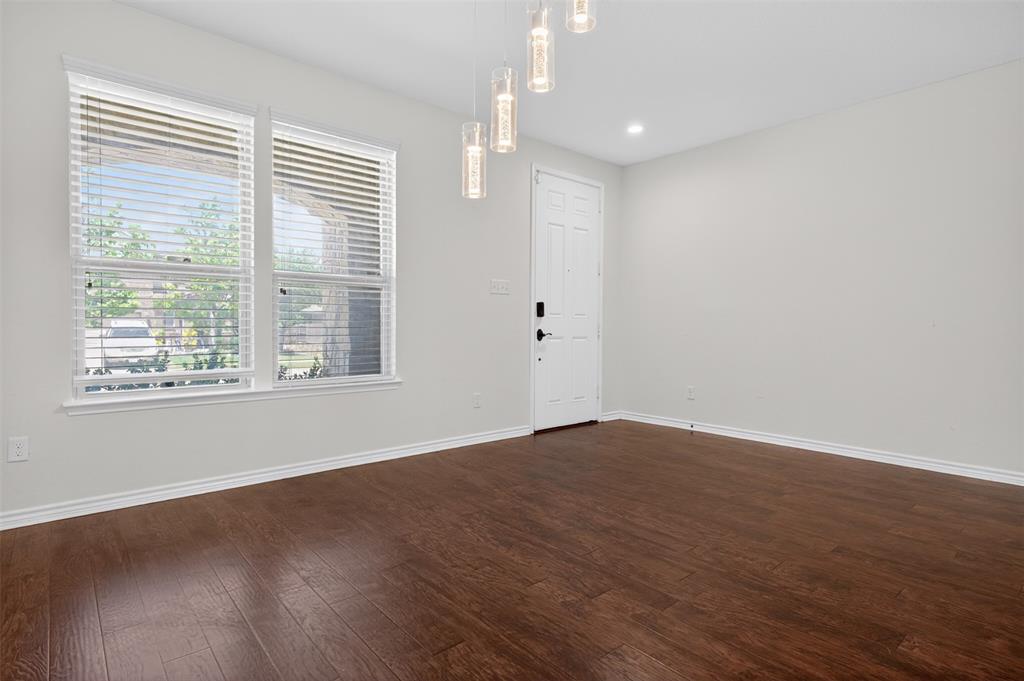 8728 Maple Ridge Trail Fort Worth, TX 76244 - Photo 11 of 40 Entryway featuring wood-finish flooring, crisp white baseboards, and a modern light fixture