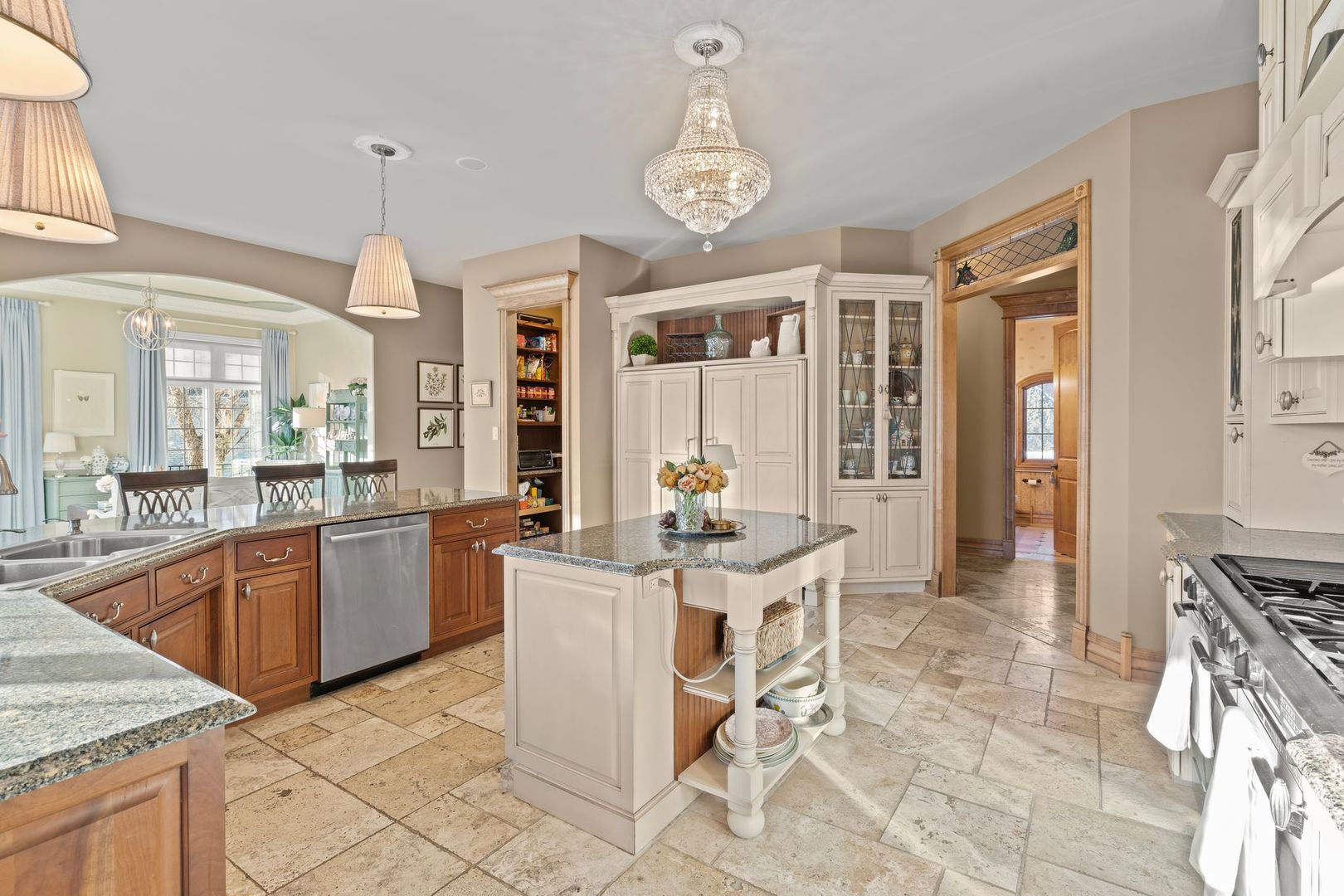 109 Singletree Road Orland Park, IL 60467 - Photo 23 of 66 a open kitchen with stainless steel appliances granite countertop a stove a sink a dining table and chairs with wooden floor