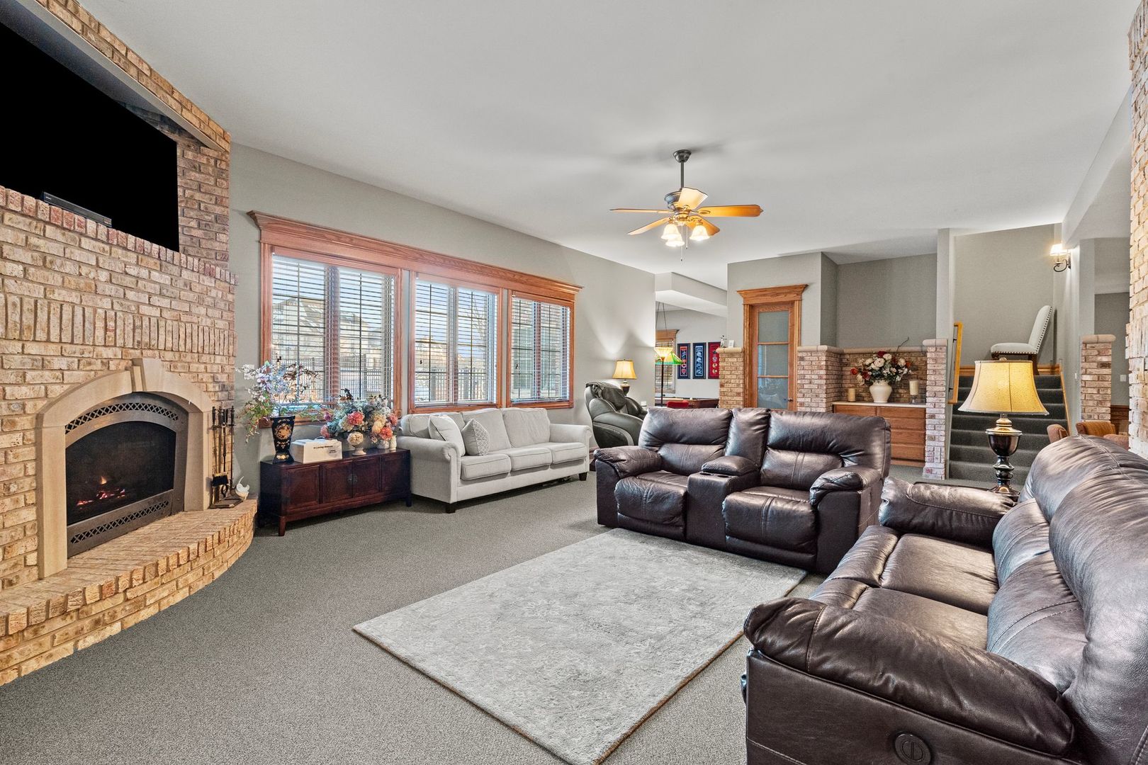 109 Singletree Road Orland Park, IL 60467 - Photo 48 of 66 a living room with furniture a fireplace and a flat screen tv