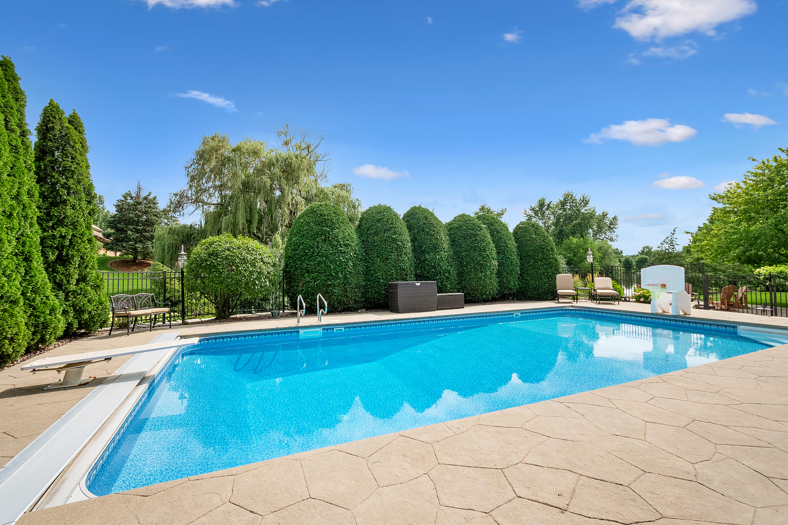 109 Singletree Road Orland Park, IL 60467 - Photo 64 of 66 a view of a swimming pool and trees in the background