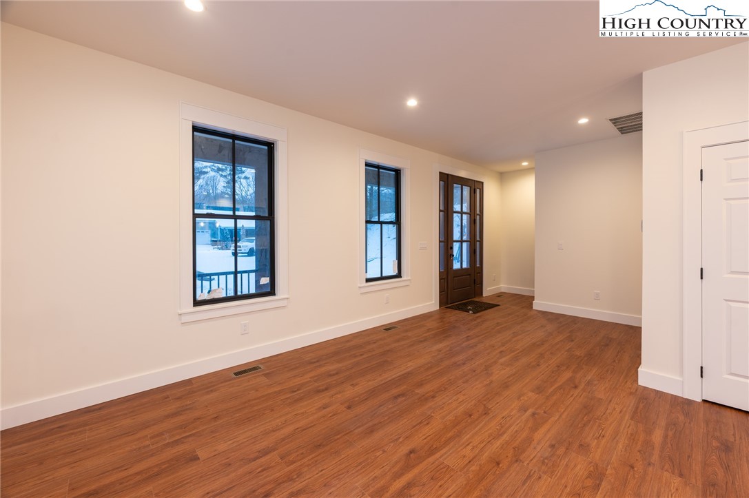 131 Bryce Way Boone, NC 28607 - Photo 16 of 38 an empty room with wooden floor and windows