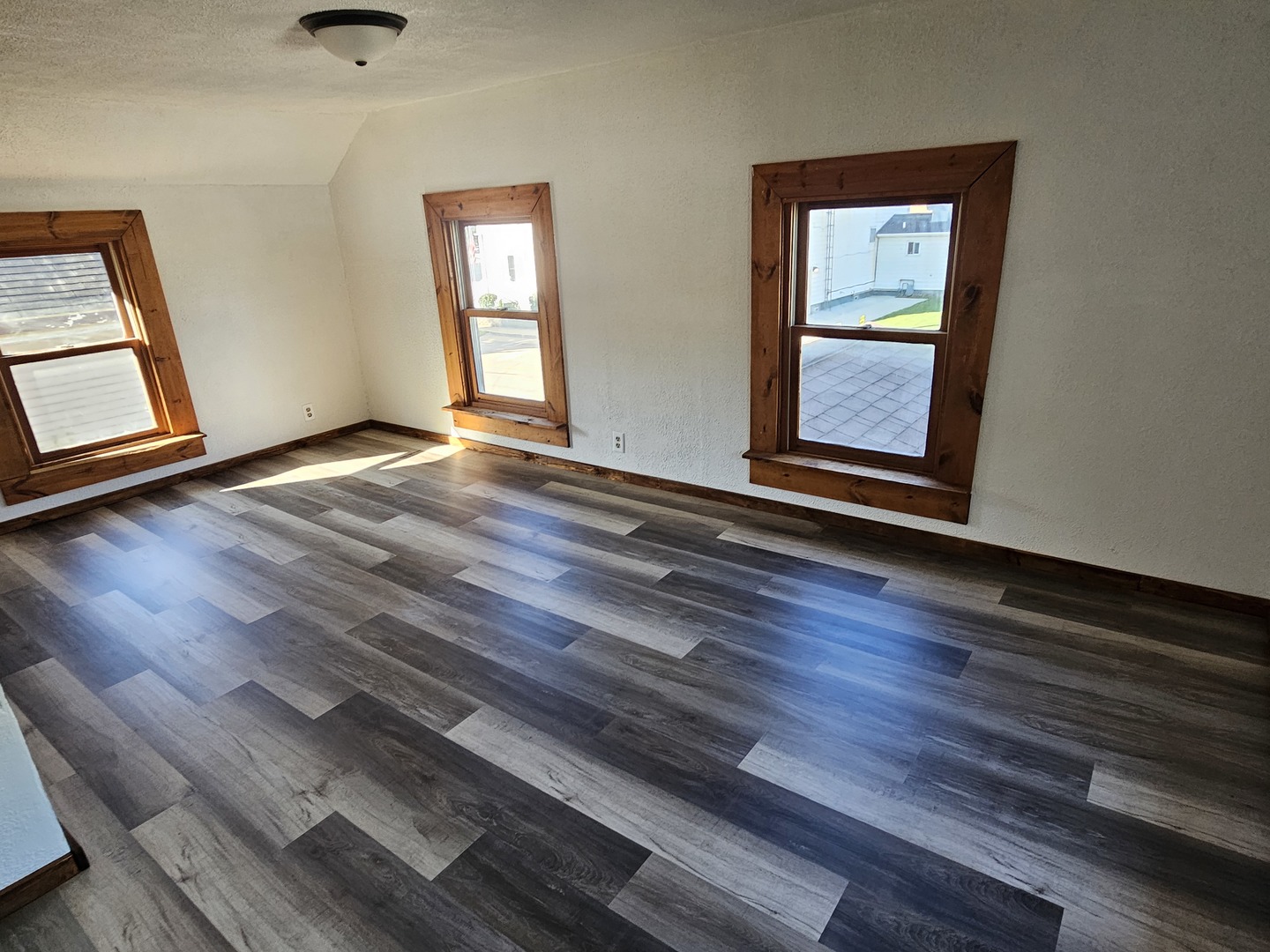 204 South Butler Street Nelson, IL 61021 - Photo 8 of 14 a view of an empty room with wooden floor and a window