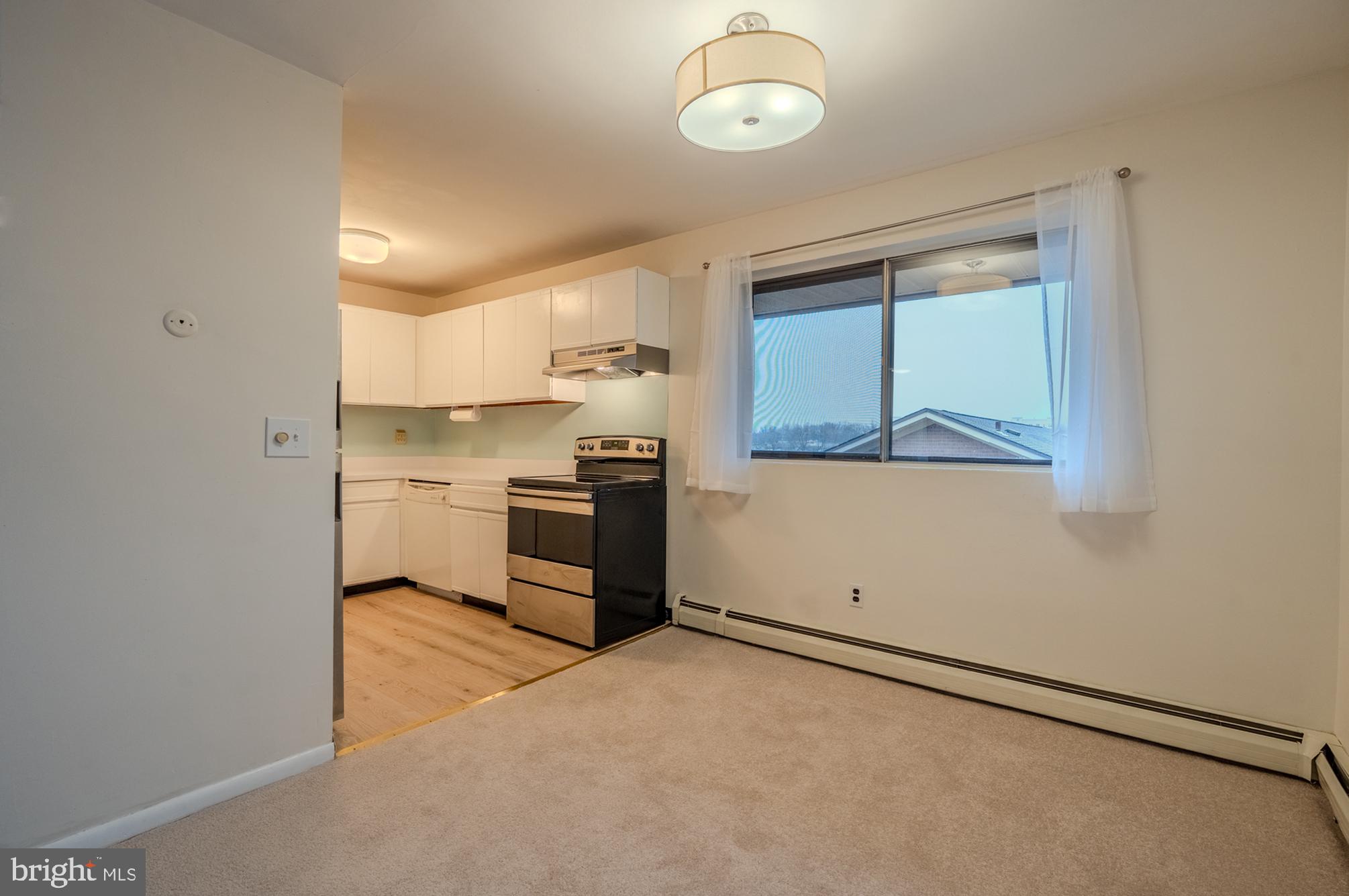 1016 West Baltimore Pike, Unit C11 Media, PA 19063 - Photo 7 of 18 a kitchen with cabinets and wooden floor