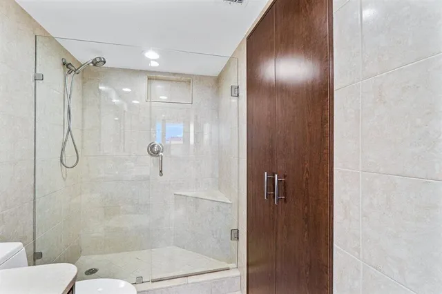 a bathroom with a glass shower door