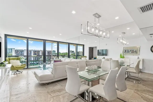 a dining room with wooden floor and a chandelier