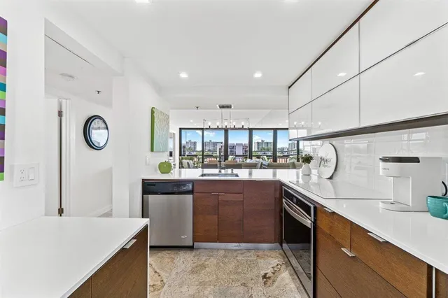 a kitchen with stainless steel appliances granite countertop a sink and stove top oven