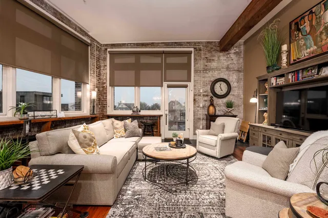 a living room with furniture a rug and a large window