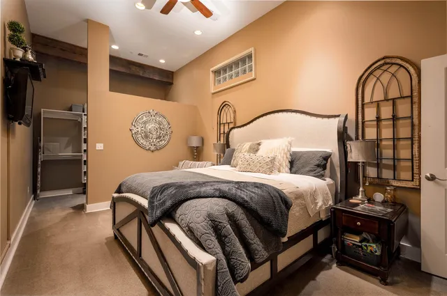 a bedroom with a bed and a dresser with the shoe rack