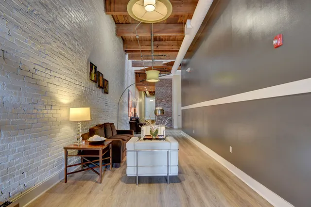 a dining room with furniture and wooden floor