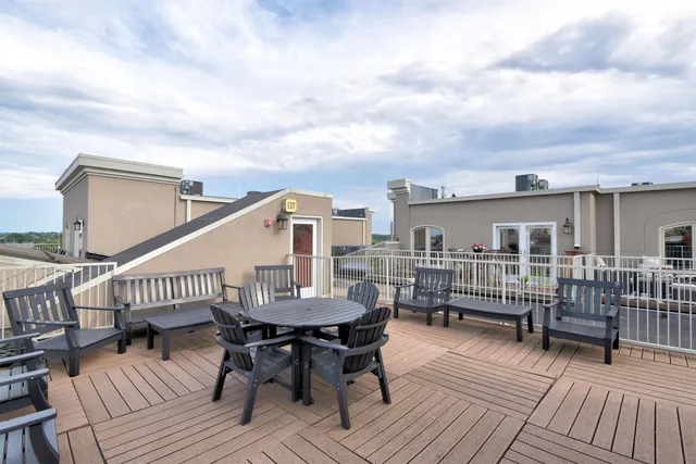 a roof deck view with a seating space