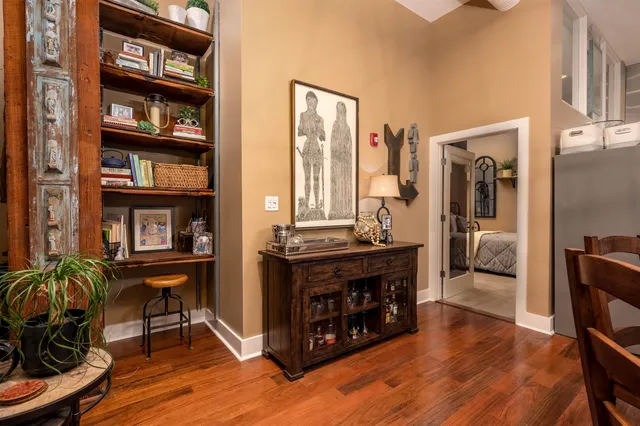 a living room with furniture a bookshelf and a window