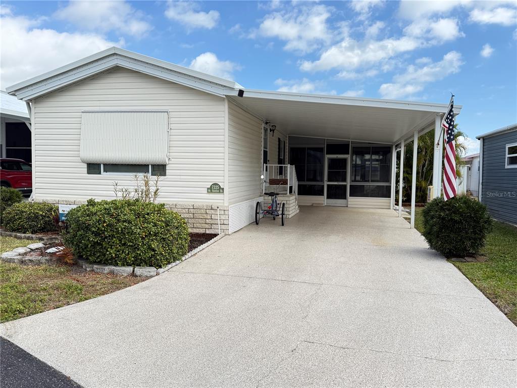 a view of a house with backyard and porch