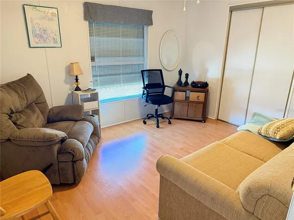 a living room with furniture a couch and a potted plant