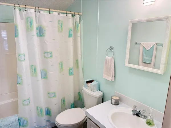 a white toilet sitting next to a bathroom sink
