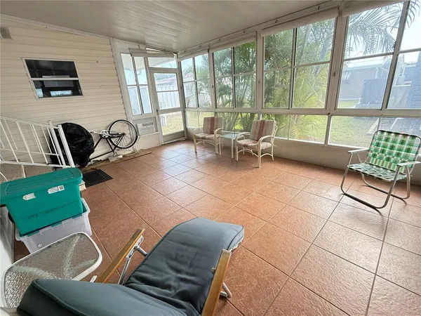 a living room with furniture and a floor to ceiling window