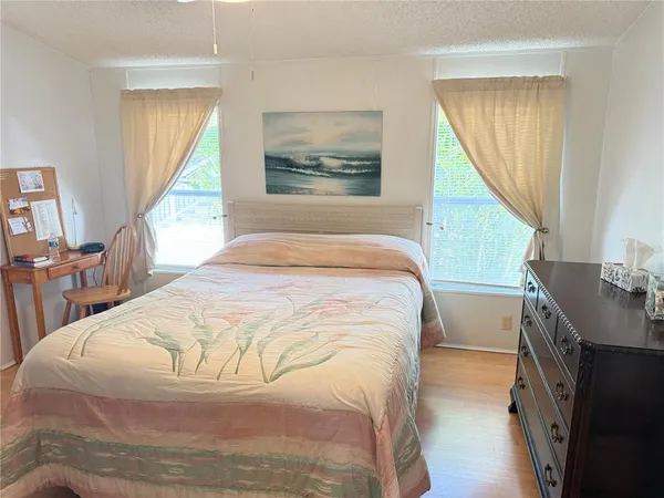 a bedroom with a bed and a large window