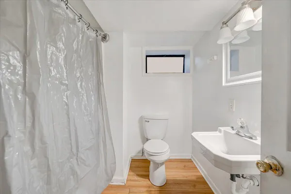 a bathroom with a toilet sink and mirror