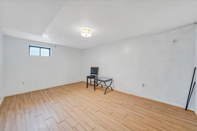 a view of a room with wooden floor and a table
