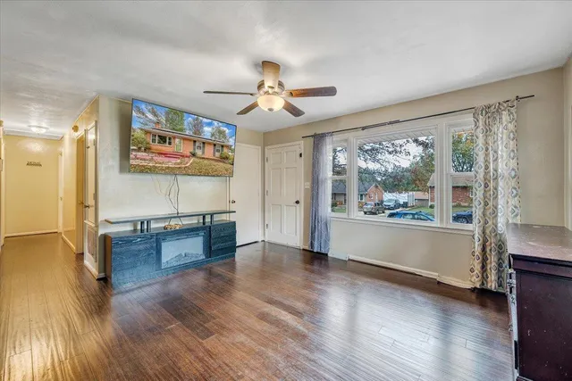 a view of a room with wooden floor and a window
