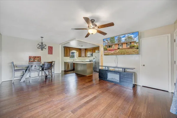 a living room with furniture and a wooden floor
