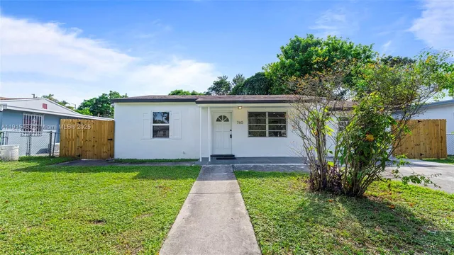 a view of a backyard with a garden and fire pit