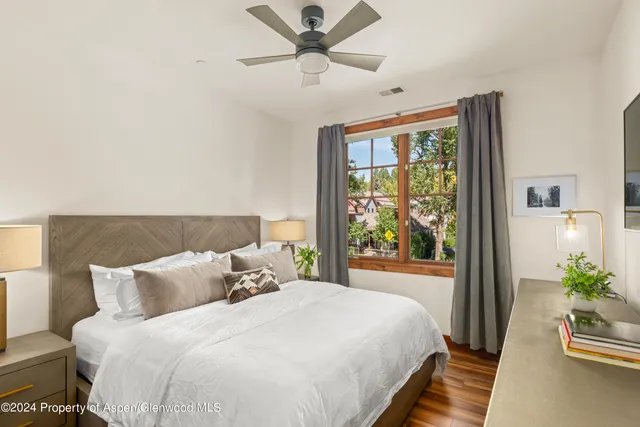 a bedroom with bed and a large window