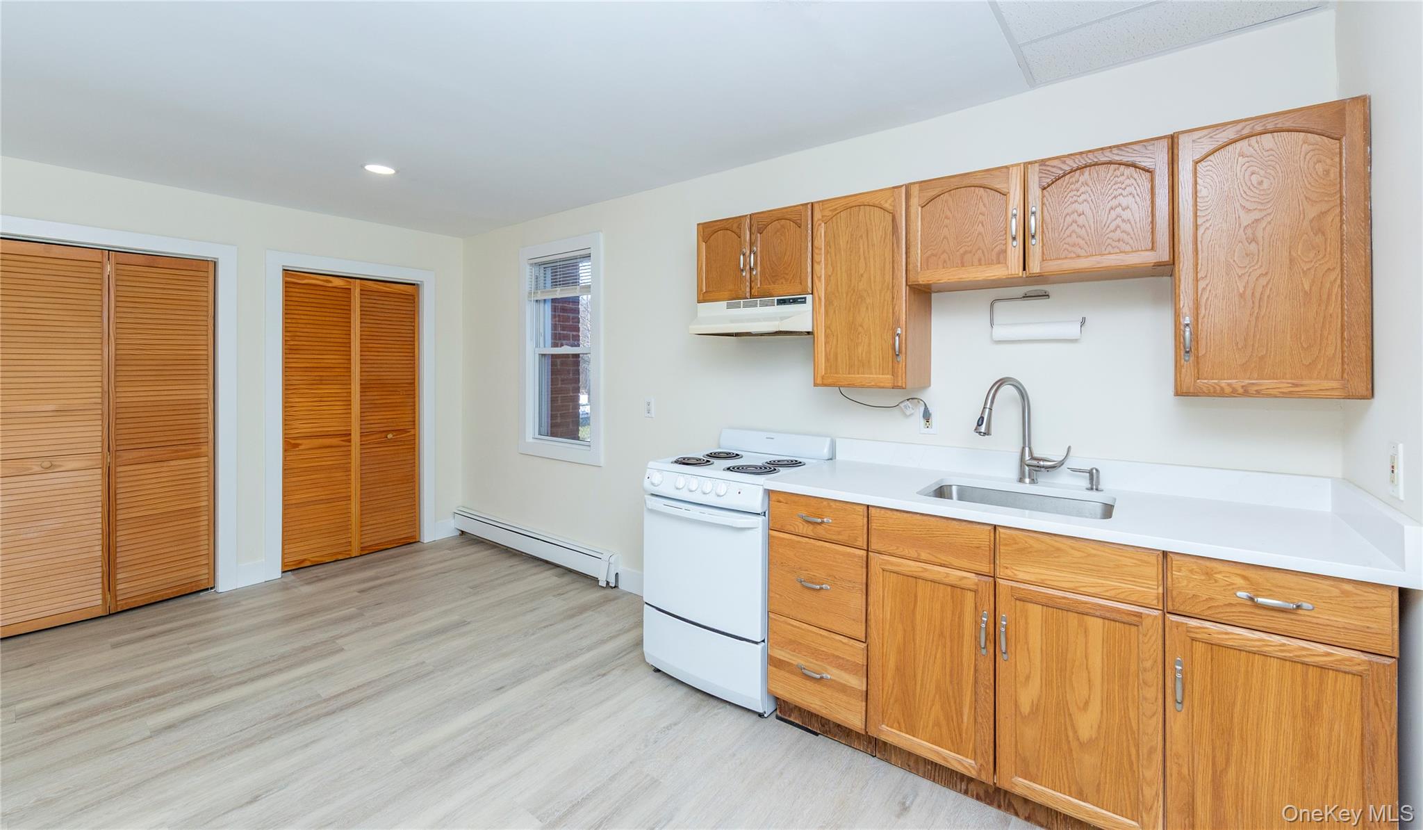 33 Holmes Road, Unit B Holmes, NY 12531 - Photo 5 of 16 a kitchen with stainless steel appliances a sink cabinets and wooden floor