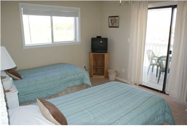 6015 Highway Santa Rosa Beach, Unit 2B 30A Santa Rosa Beach, FL 32459 - Photo 5 of 11 a bedroom with a bed and large windows