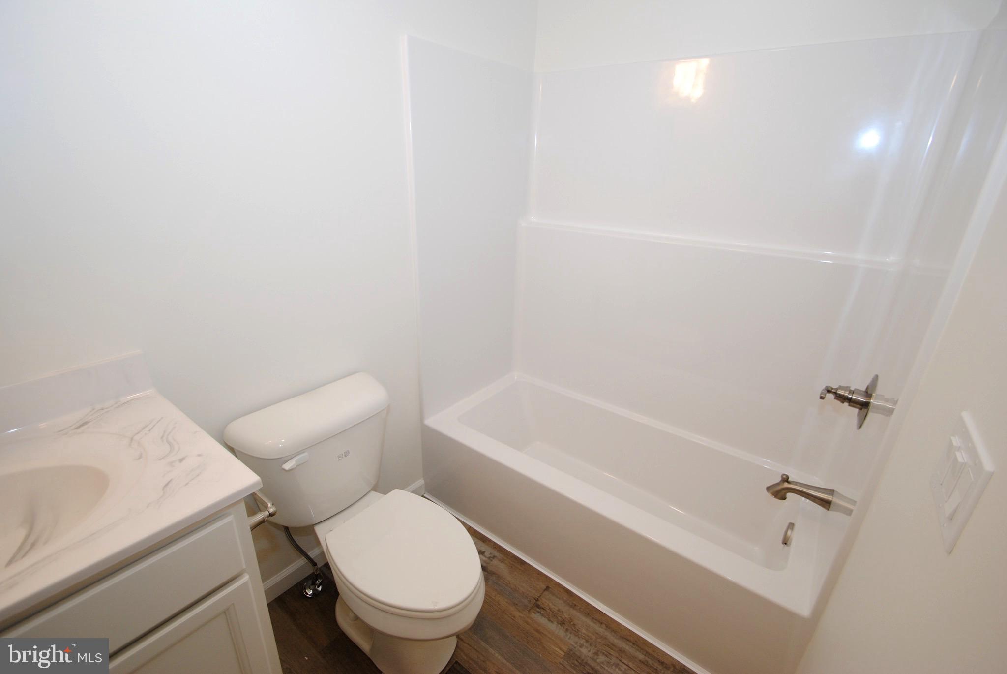 119-121 West 3rd Street Moorestown, NJ 08057 - Photo 14 of 25 a white toilet and tub sitting next to a bathroom sink